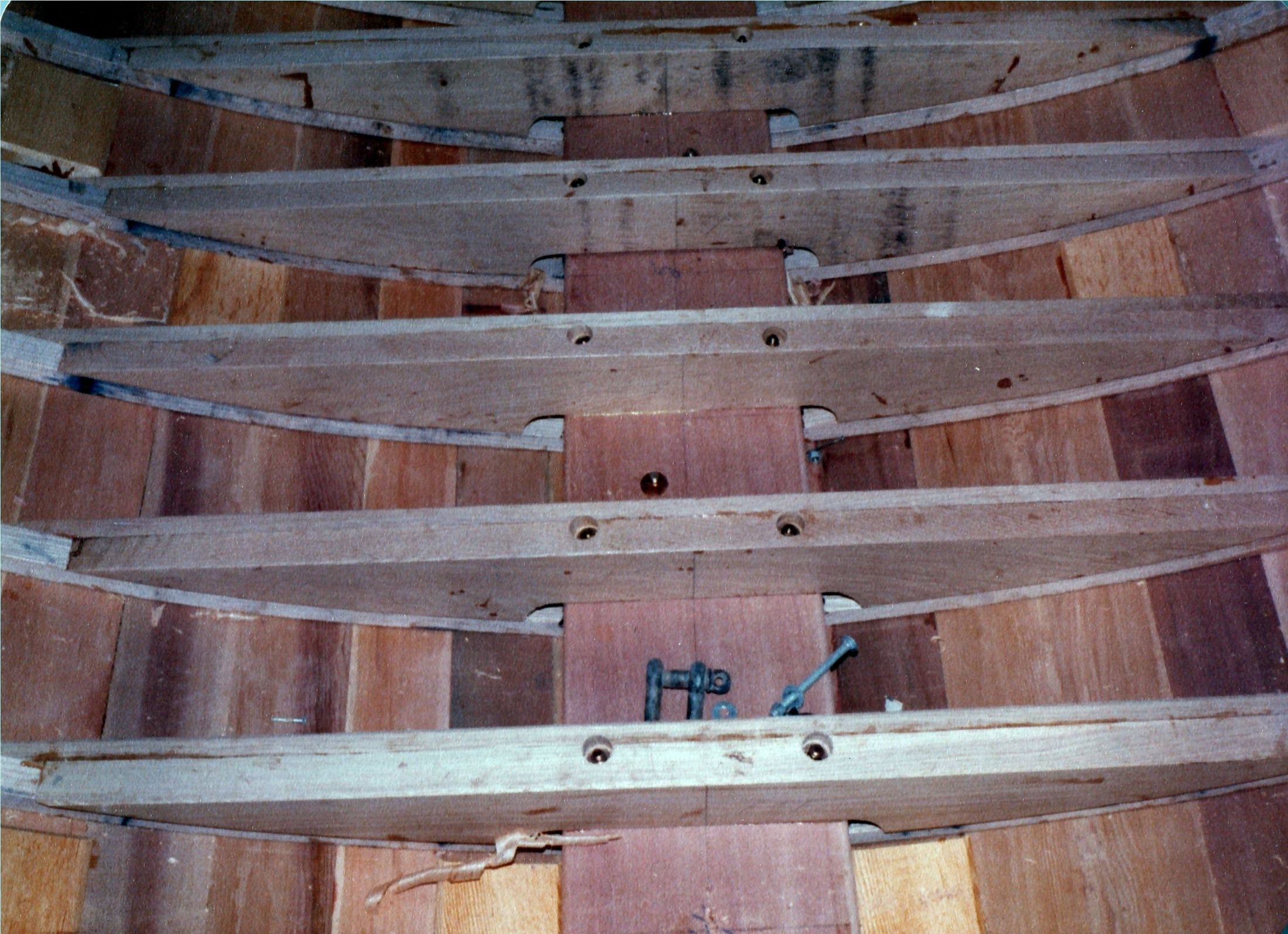 The shelf and clamp notched over the frames, bolts through