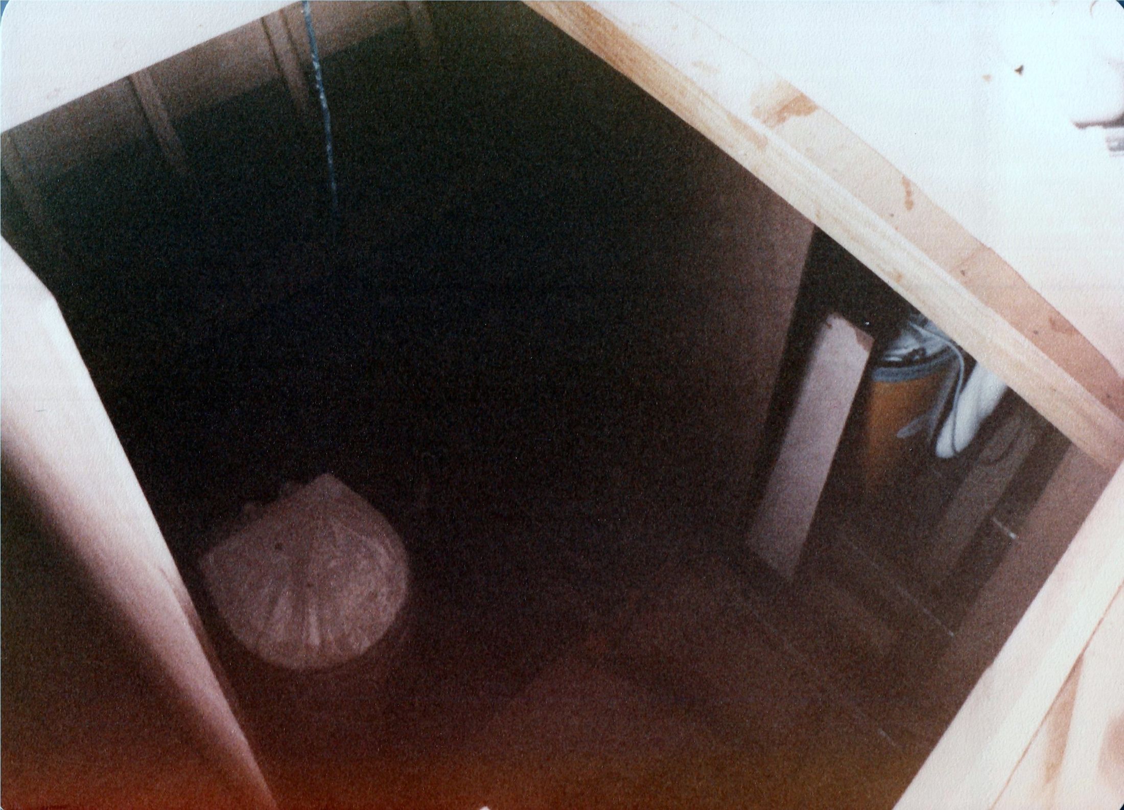 Inside the cabin, a lamp hanging in the dark