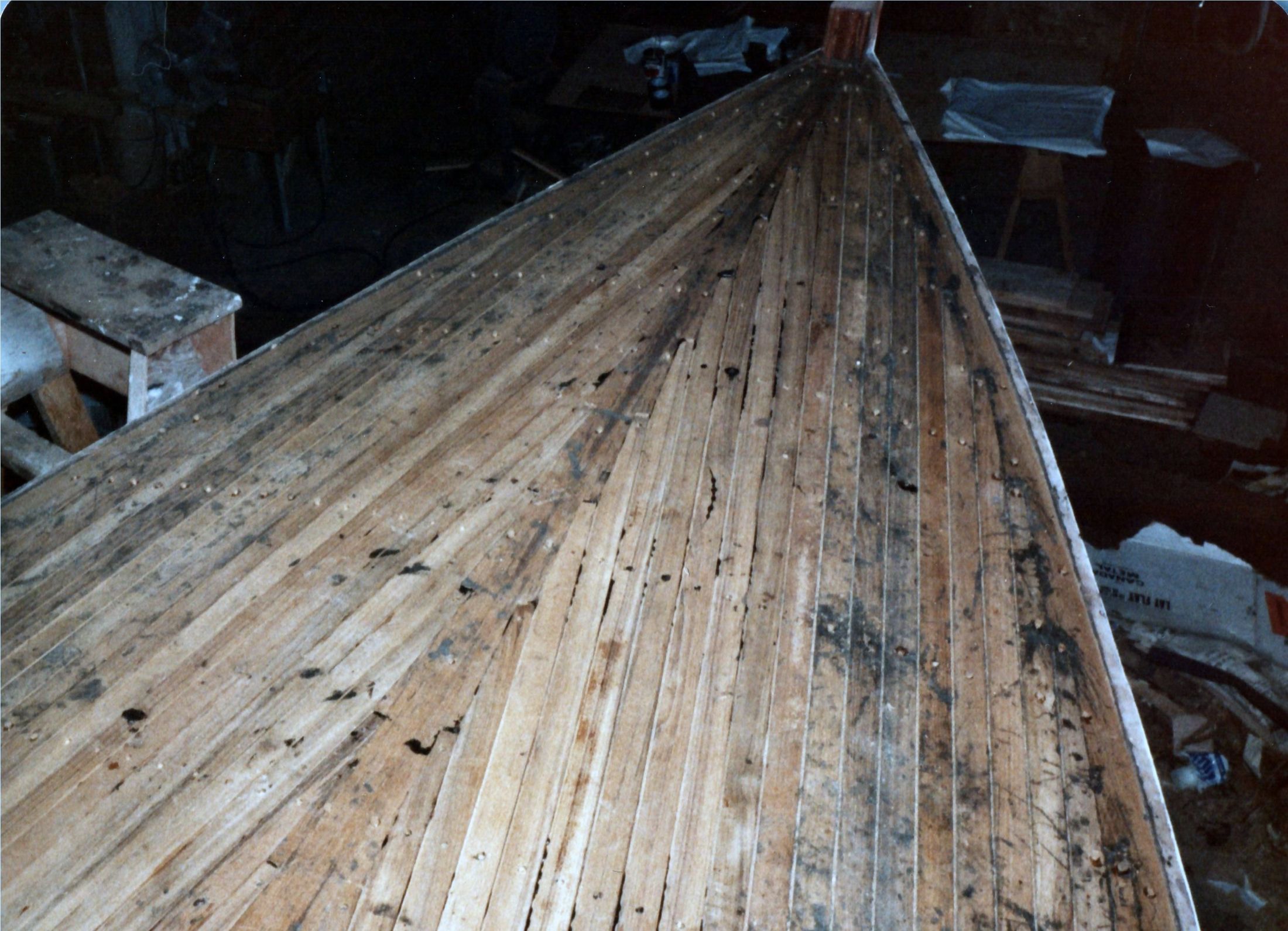 The laid teak deck from the bow, plugs over the screws