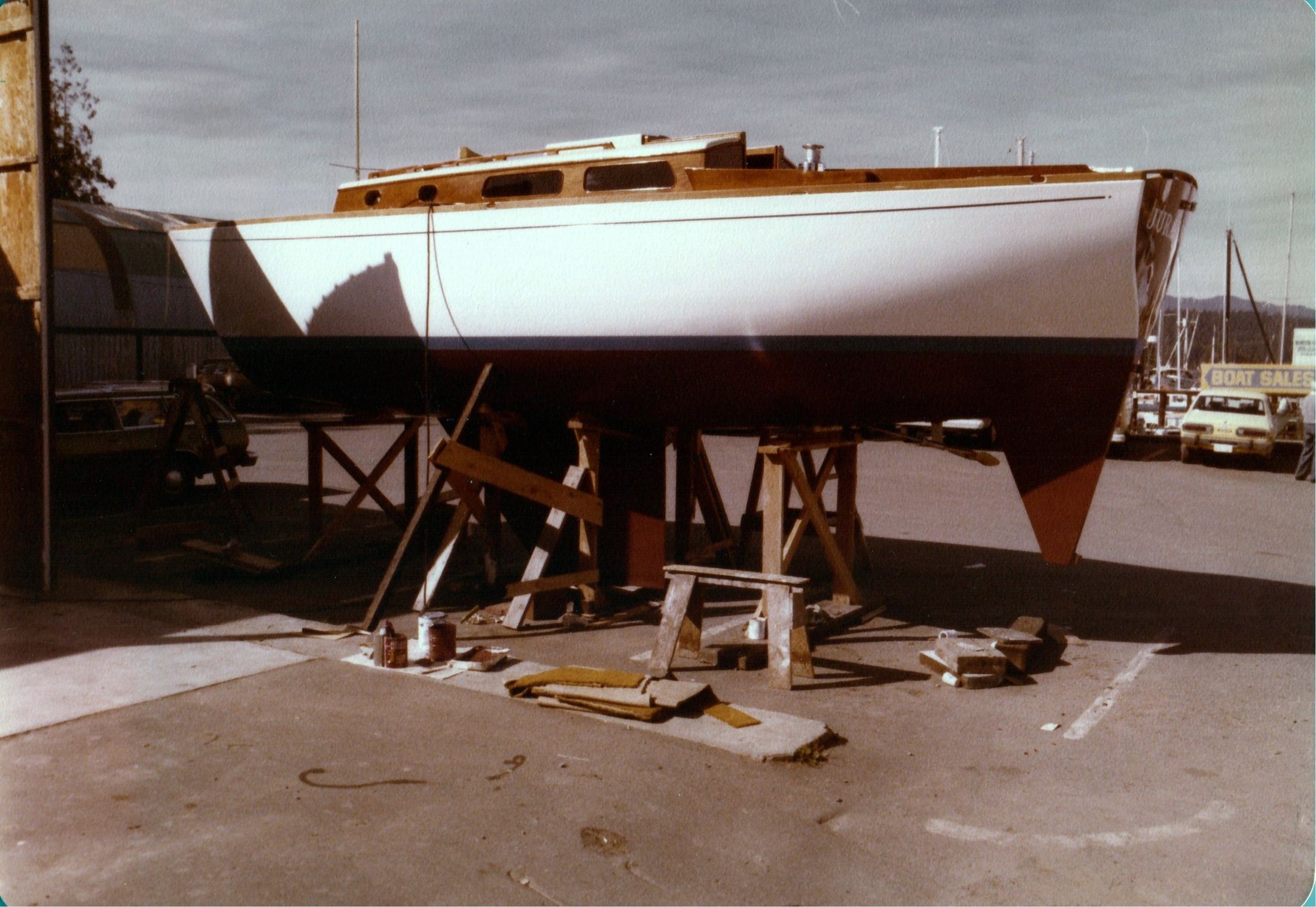 The boat on cradles in the yard, cabin and deck finished
