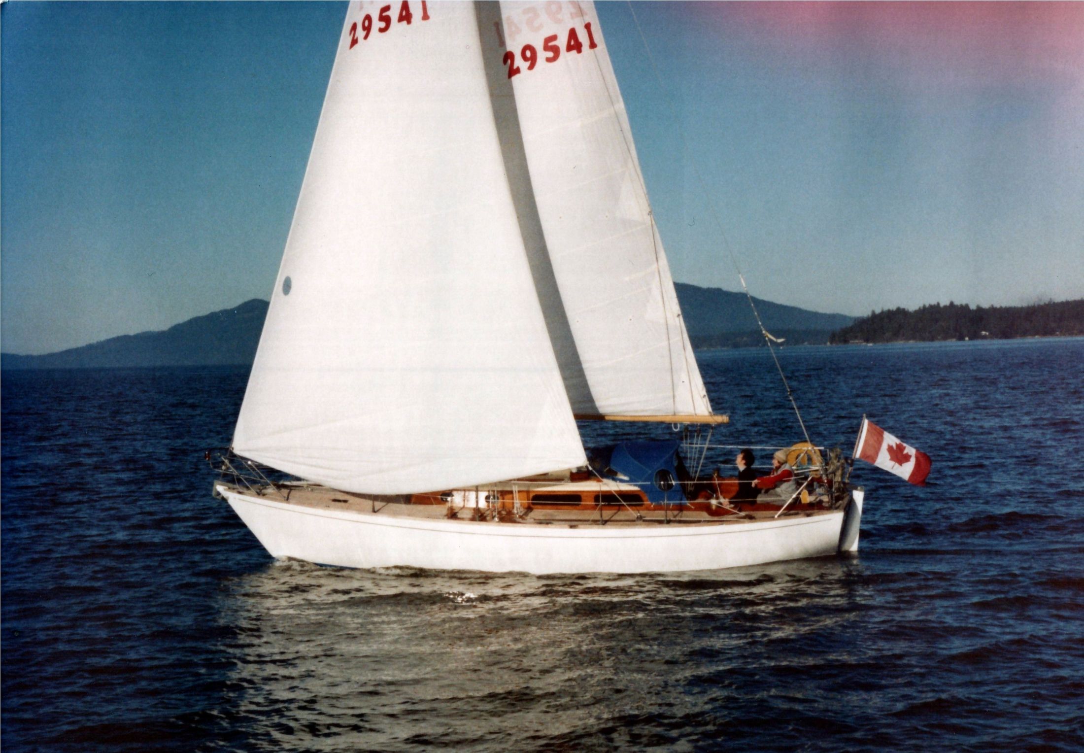 Jura under full sail, sail number 29541, a Canadian flag at the stern