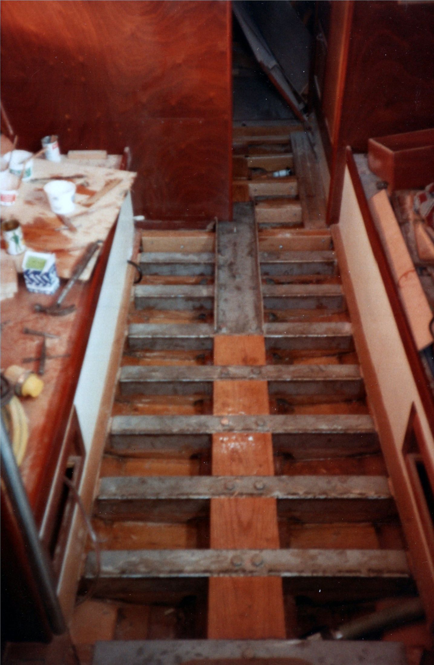 The companionway steps in teak, looking down into the cabin